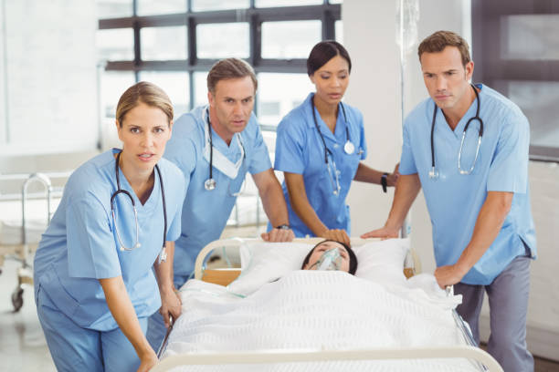 istock Group of doctors carrying woman patient 673801794