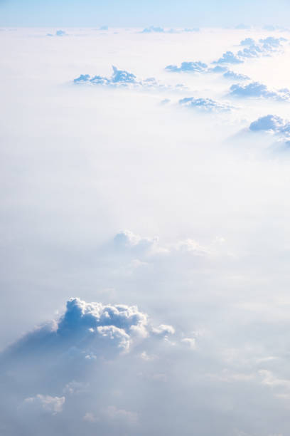 istock Clouds in blue sky, aerial view from airplane window. 673804142