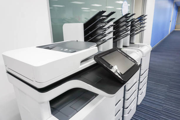 close up office printers set up ready for printing business documents stock photo