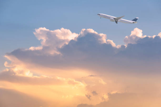 istock Commercial airplane flying over sunrise sky and clouds. 673812092