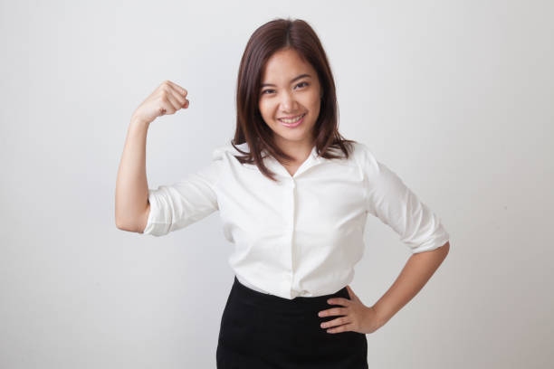 istock Beautiful young Asian woman flex bicep. 673812712