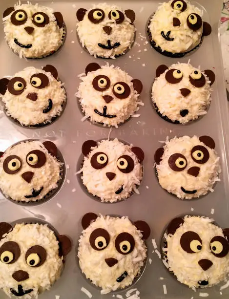 Playful, black and white panda cupcakes are a great children’s party treat.