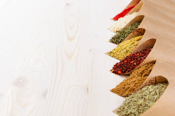 istock Colorful powder seasoning pattern on white wooden board with copy space. 673818398