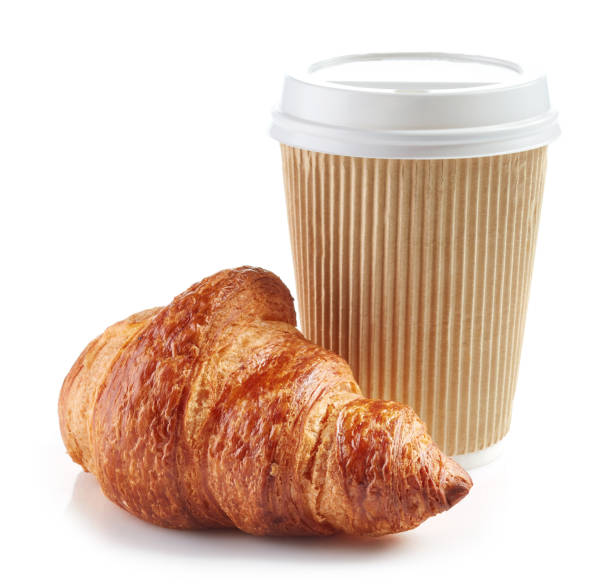 istock paper cup of coffee and croissant 673822190