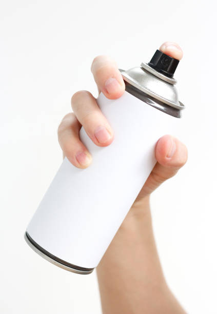 istock Man's hand holds a spray of black paint. Isolated on a white background 673822352