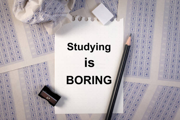 istock Filling out in answer sheet, pencil, sharpener, paper reduction and the word studying is boring. 673825270