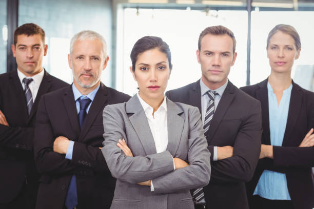 istock Businesspeople standing with arms crossed 673826266