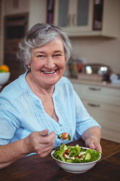 istock Happy senior woman having vegetable salad 673828344