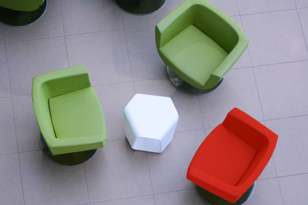 istock Top view two green chairs and one red with a white table 673828438
