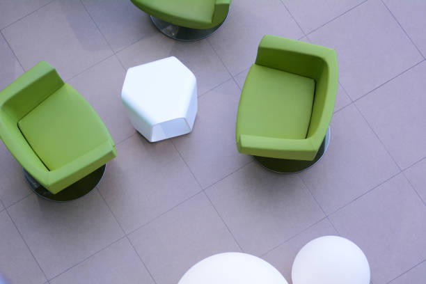 istock Top view of three green armchairs with a white table 673828472
