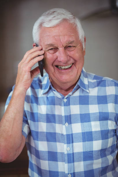 istock Smiling senior man talking on phone 673828640