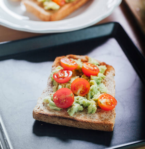 istock Healthy avocado, egg open sandwiches on a plate with cherry tomatoes,vintage theme 673828706