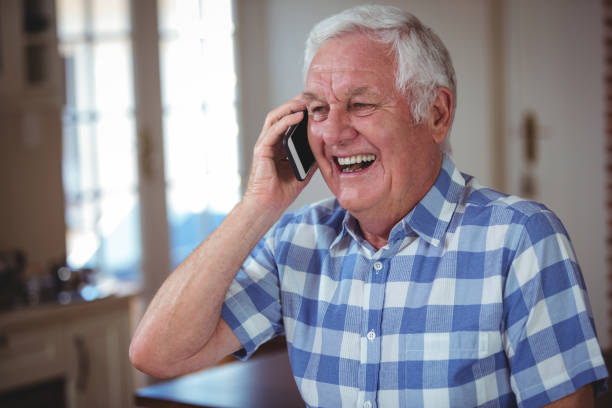 istock Cheerful senior man talking on mobile phone 673829208