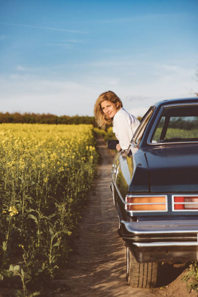istock Young woman resting in car window during road trip. 673829840