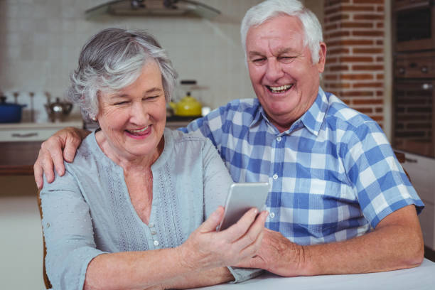 istock Loving senior couple using mobile phone 673833234