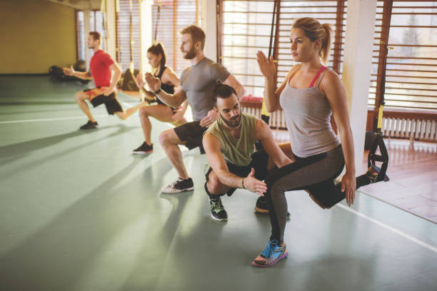 istock Young body conscious people having TRX training in a gym. 673833624