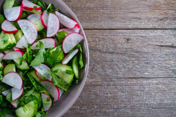 istock Vitamin spring salad: green onion, radish, cucumber, arugula . 673835910