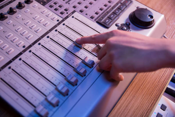 Professional audio mixing console with faders and adjusting knobs stock photo