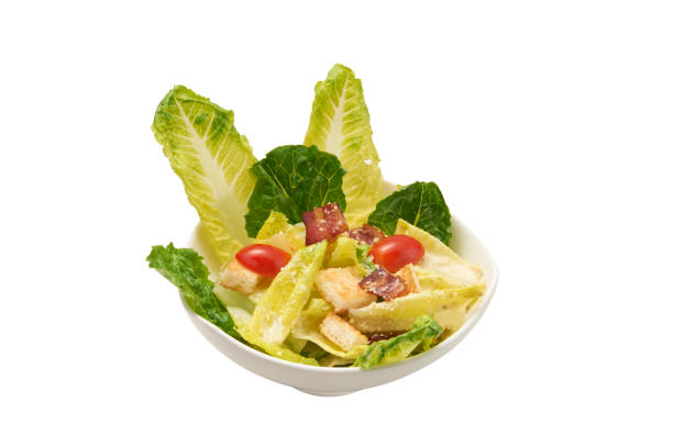 istock Isolated of ceasar salad in white plate. Clipping path and white background. 673843762