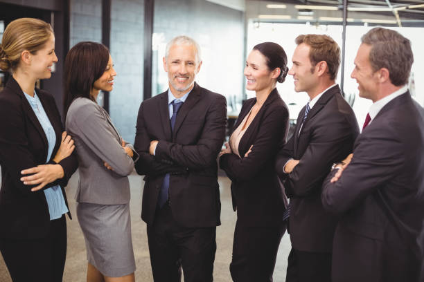 istock Businesspeople standing together with arms crossed 673844302