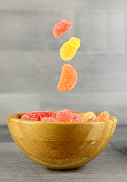 Falling Gummy Bear Candy Colorful Background on wood Falling Gummy Bear Candy Colorful Background on wood pick and mix stock pictures, royalty-free photos & images