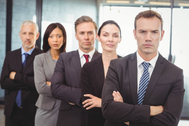 istock Businesspeople standing with arms crossed 673844866