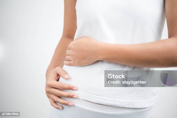 Young Female Touching Her Right Side In Pain Kidney Inflammation And Therapy Medicine And Health Care Concept White Background Stock Photo - Download Image Now