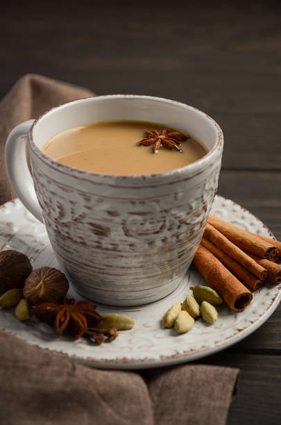 istock Indian masala chai tea. Spiced tea with milk on the rustic wooden table. 673847854
