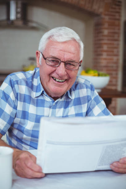 istock Happy senior man with newspaper 673850554