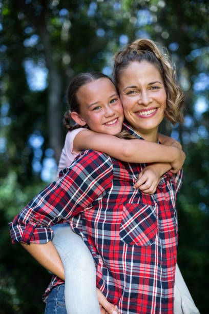 istock Mother carrying daughter on back 673851218