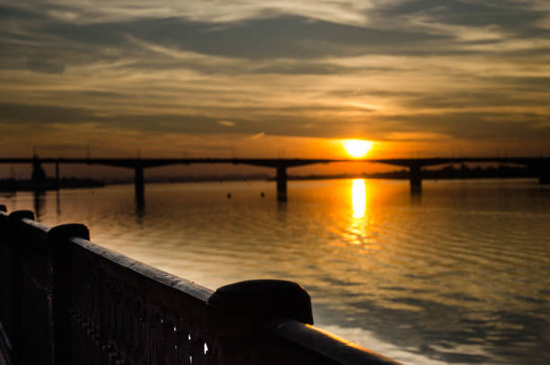 Sunset over the river above the bridge