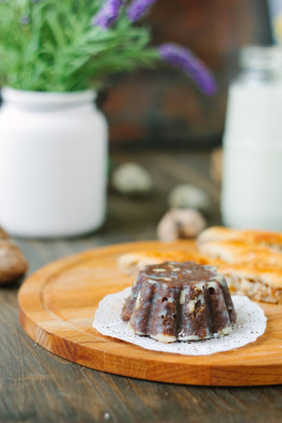 Chocolate cake on wooden board over dark background