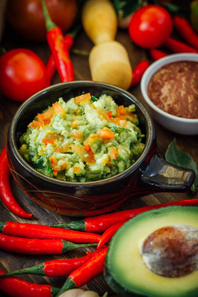 istock Guacamole and salsa - two hot mexican vegetarian dips. 673851998