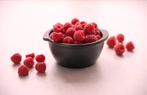 istock fresh organic raspberries in a bowl on the marble table 673854912