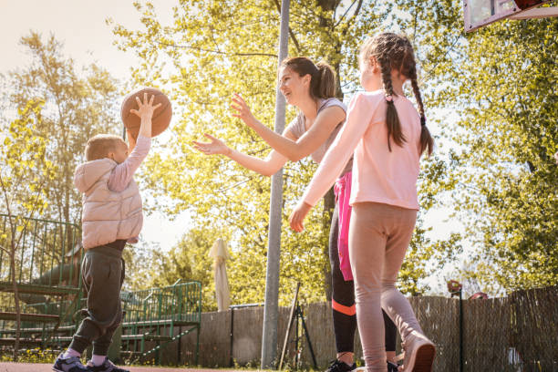 istock Mother with her children playing basketball. 673858512