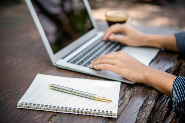 istock Woman hand using laptop computer on wooden table 673861468