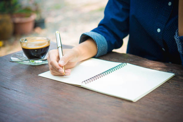 istock women writing and key board coffee on wooden table 673861570