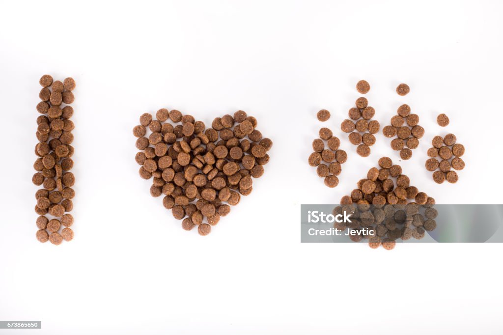 Text from dog's granules Text I love dogs shaped from doggy dry food into heart and paw. Isolated on white background Dog Stock Photo