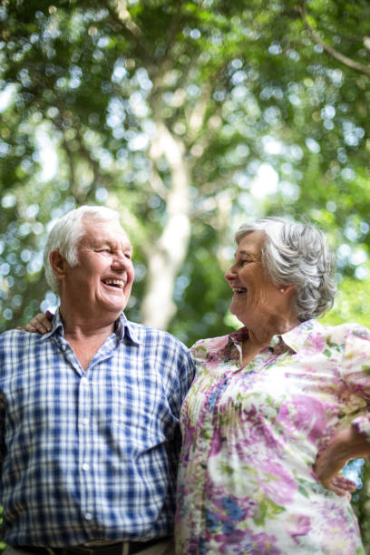 istock Happy senior couple laughing while looking at each other 673865680