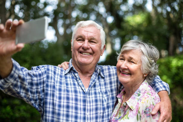 istock Cheerful senior couple taking selfie in back yard 673865942