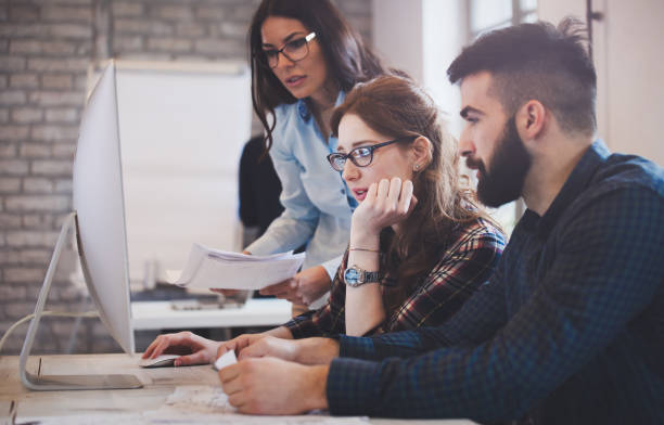 istock Happy creative coworkers working in designer office 673866980