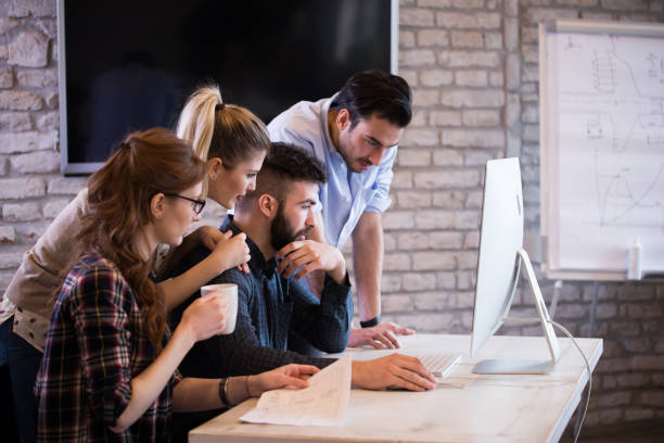 istock Happy creative coworkers working in designer office 673869300