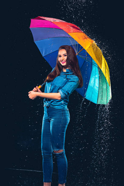istock Young beautiful woman with an umbrella 673869516