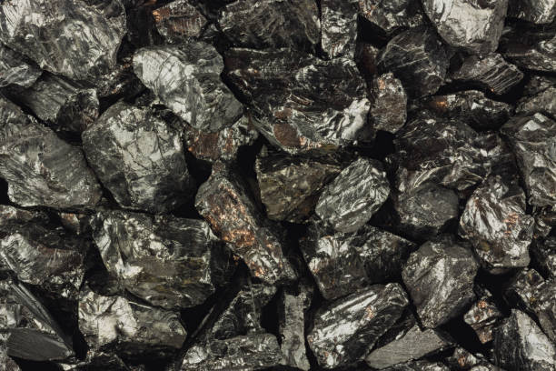 istock Background of black raw coal pieces close up 673869606