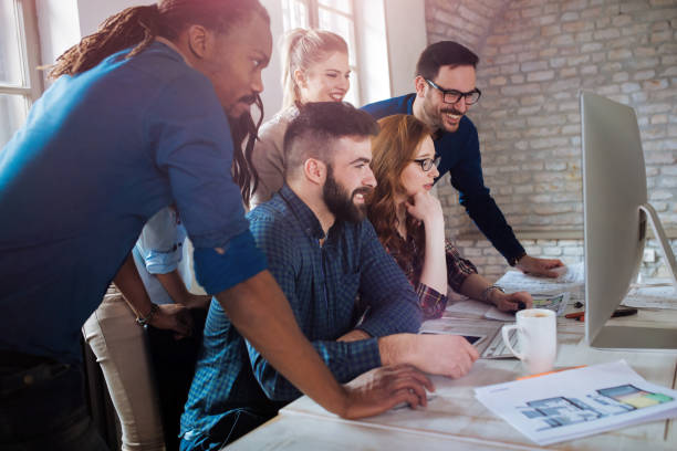 istock Happy creative coworkers working in designer office 673870342