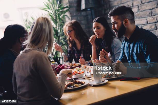 Group Of Happy Business People Eating Together In Restaurant Stock Photo - Download Image Now