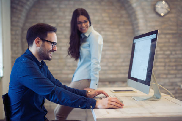 istock Coworking and corporate colleagues working in designer architect office 673873344