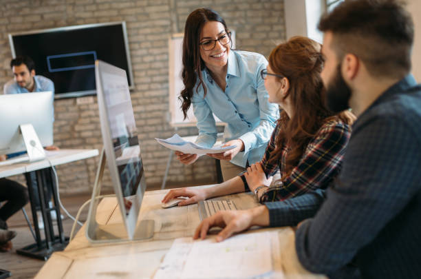 istock Happy creative coworkers working in designer office 673873872
