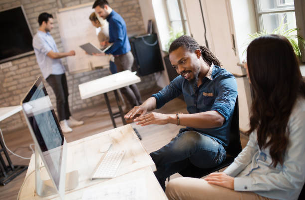 istock Happy creative coworkers working in designer office 673875442