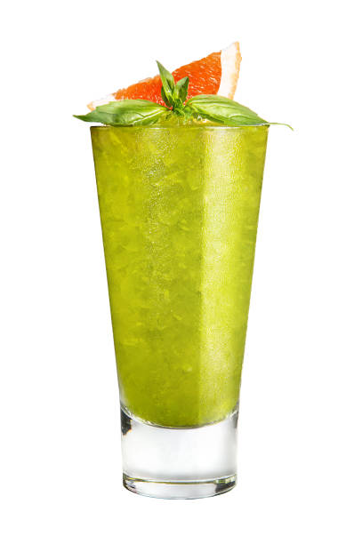 Refreshing fruit cocktail with ice. Green with decoration basil and orange on a white background, isolated